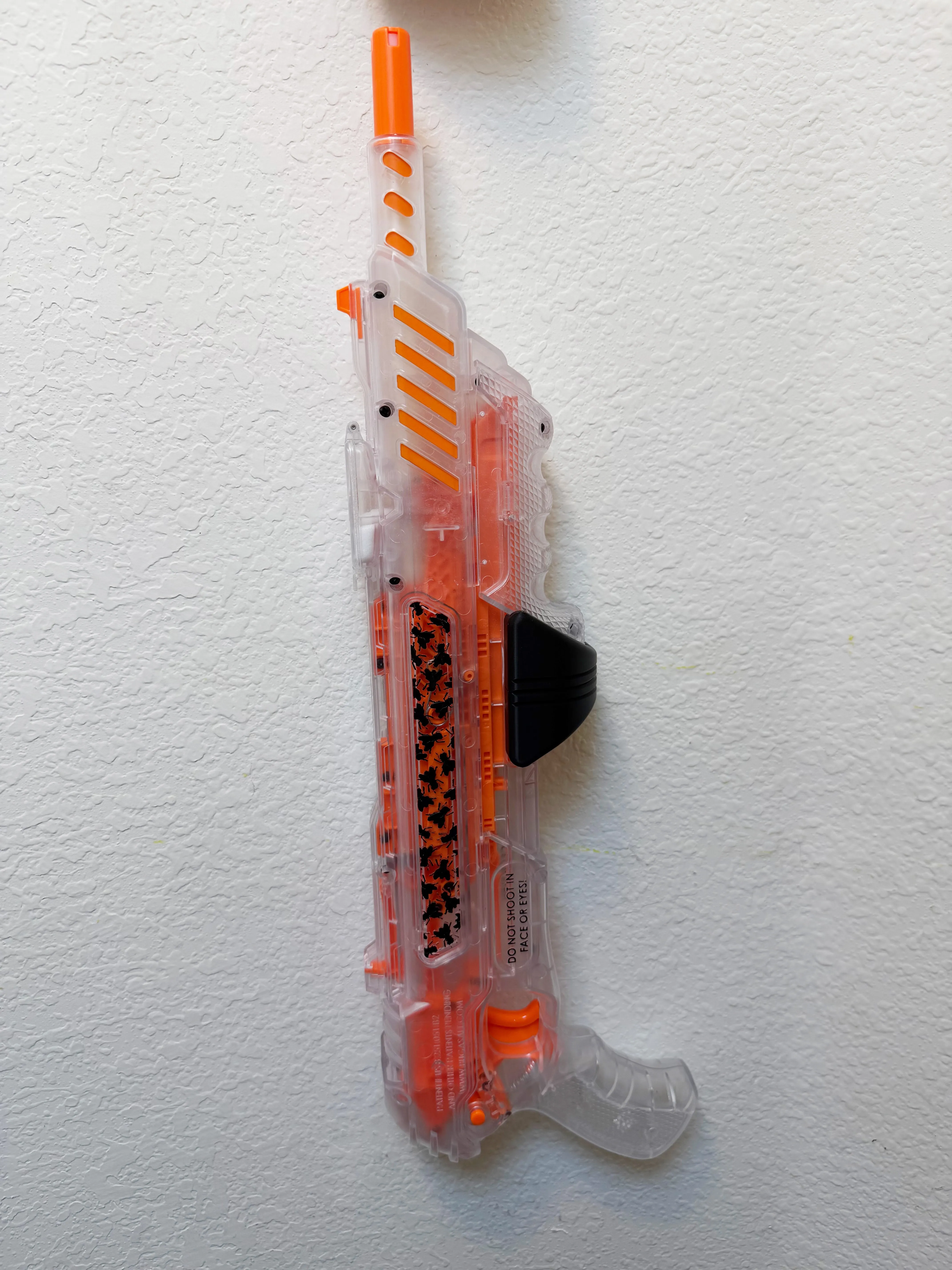 Bug-A-Salt V3 hanging vertically on a wall in the black 3D-printed wall mount